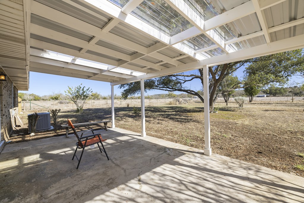 341 Stoneleigh Road Center Point, TX 78010 - Photo 13 of 25 a view of a porch with furniture and a gate