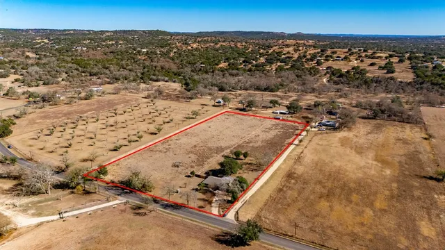 an aerial view of a residential building and parking space