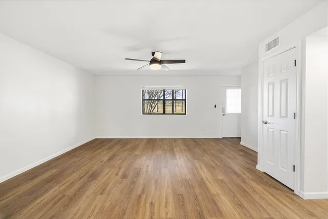 wooden floor in an empty room with a window