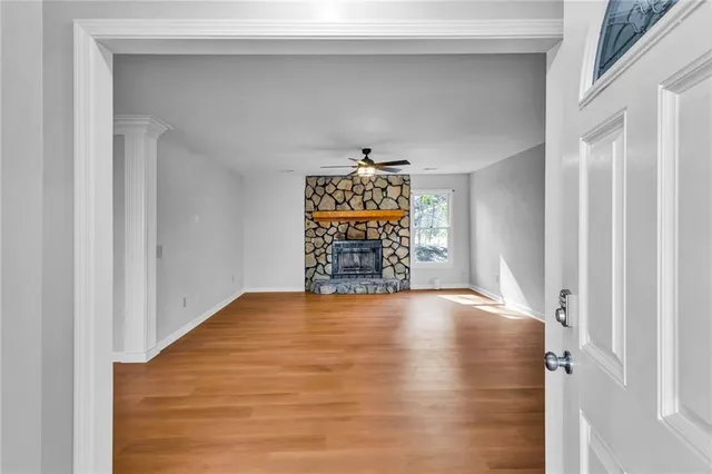 a view of an empty room with window and closet area