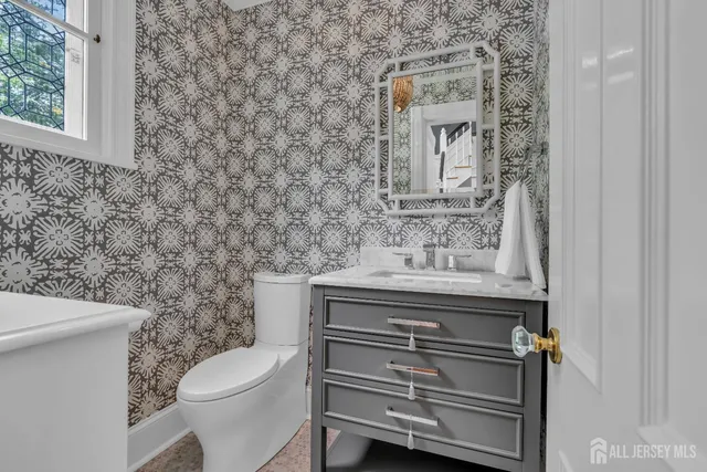 a living room with furniture a chandelier and a mirror