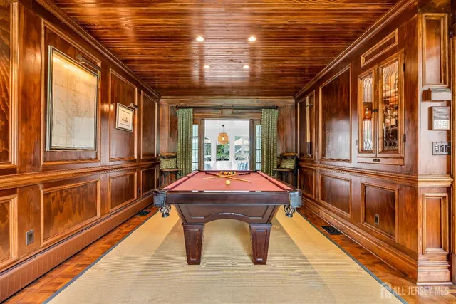 a dining room filled chandelier and wooden floor