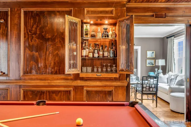 a bathroom with a sink a mirror and next to a window