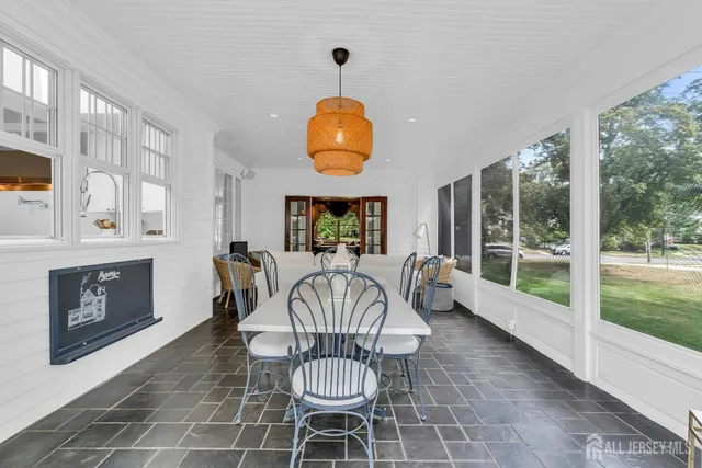 a kitchen with a sink a counter and a dining table with wooden floor