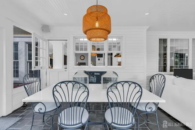 a kitchen with stainless steel appliances granite countertop a stove a sink dishwasher and white cabinets with wooden floor