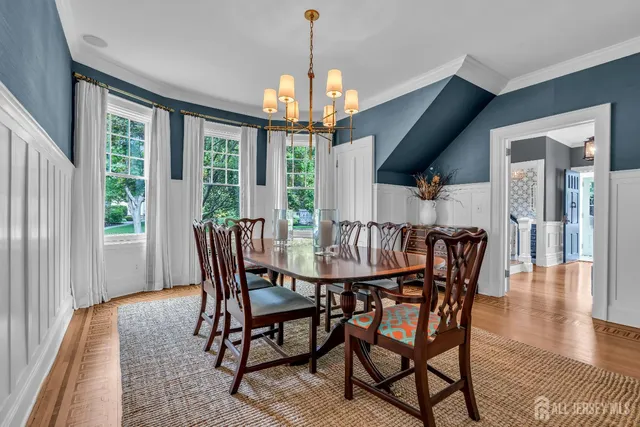 a kitchen with stainless steel appliances granite countertop a sink and a chandelier