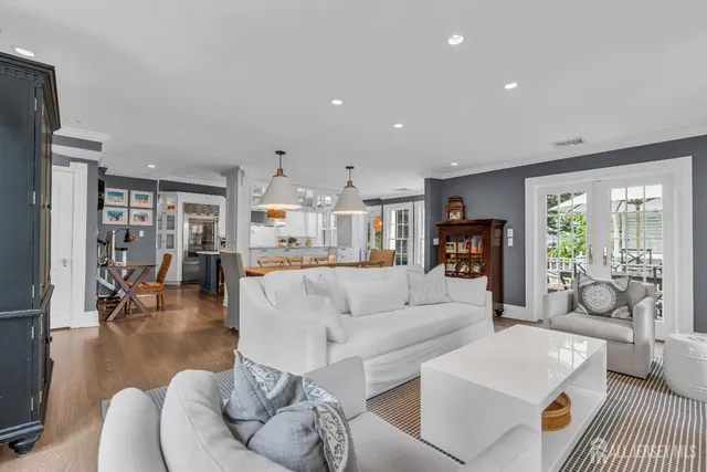 a view of a patio with couches table and chairs and potted plants