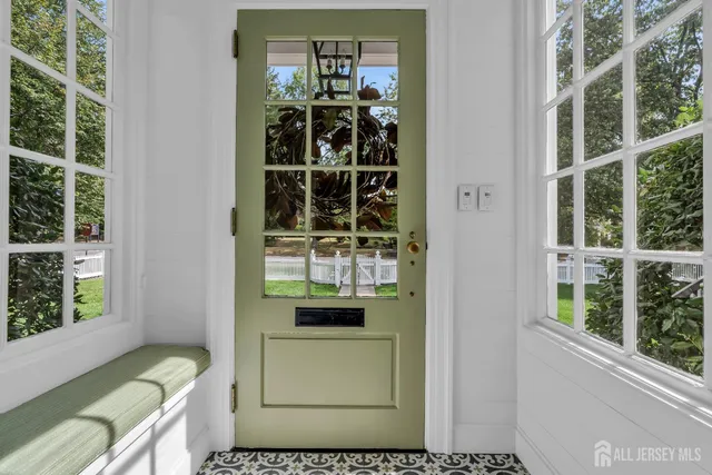 a living room with furniture a rug and a bookshelf