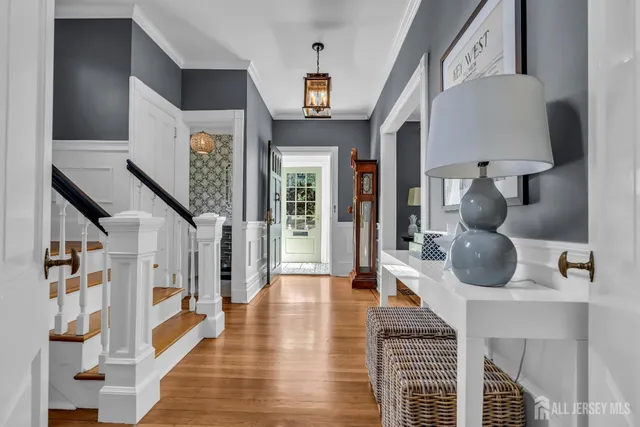a room with stainless steel appliances wooden floor and chandelier