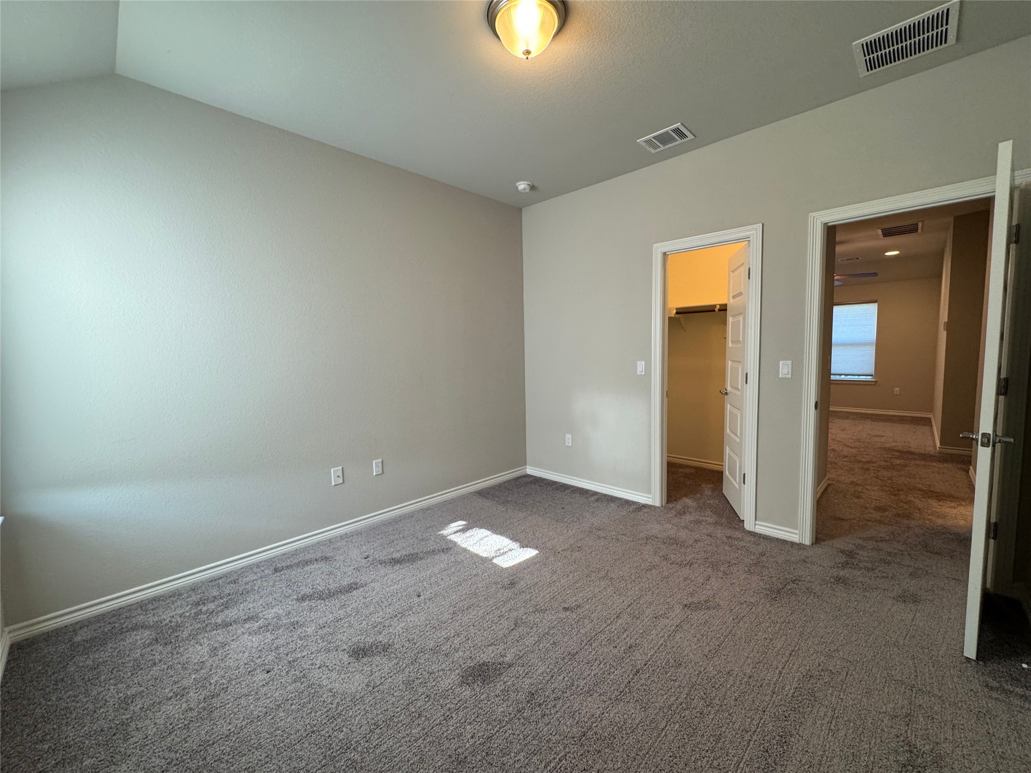 14100 McCoy Loop, Unit 1 Austin, TX 78717 - Photo 31 of 39 A well-lit bedroom with fresh carpet and convenient closet access.