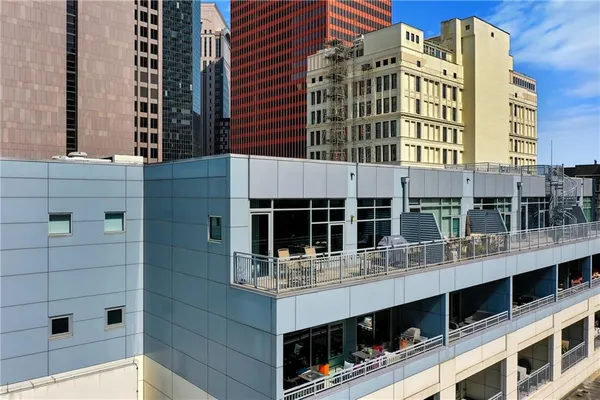 a kitchen with stainless steel appliances kitchen island granite countertop a refrigerator and a stove top oven