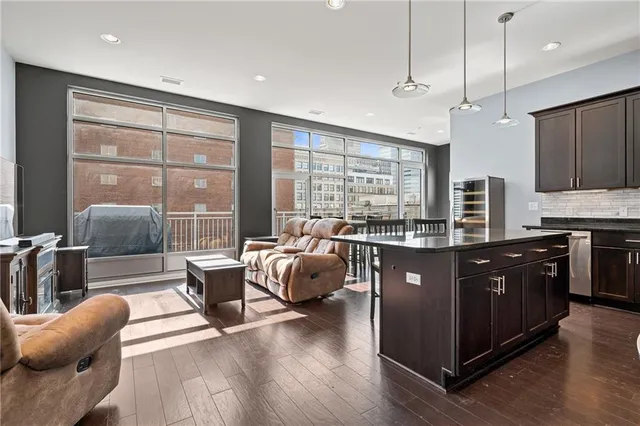 a kitchen with stainless steel appliances a refrigerator a stove a microwave a center island and a refrigerator