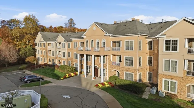 a front view of a house with yard and green space