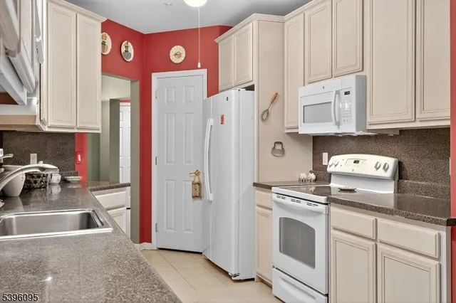 a kitchen with stainless steel appliances granite countertop a refrigerator and a stove