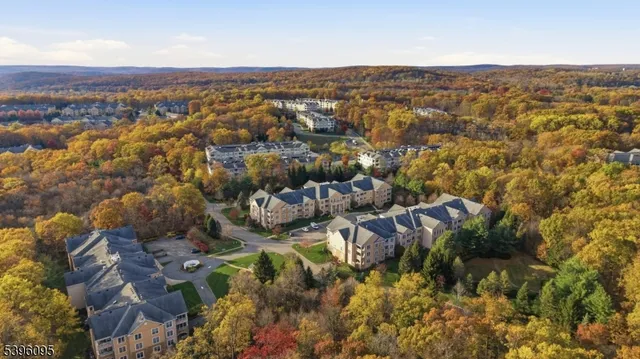 an aerial view of residential house with parking and yard