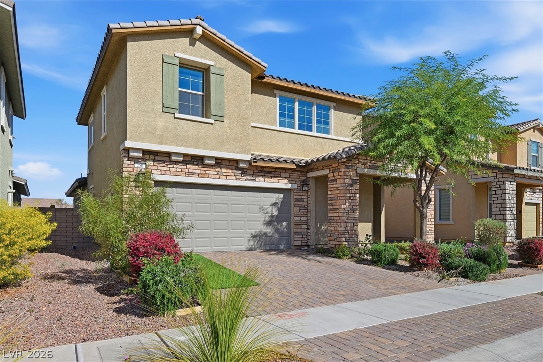 250 Dedication Avenue Henderson, NV 89011 - Photo 2 of 67 Mediterranean / spanish home with stone siding, stucco siding, an attached garage, and a tiled roof