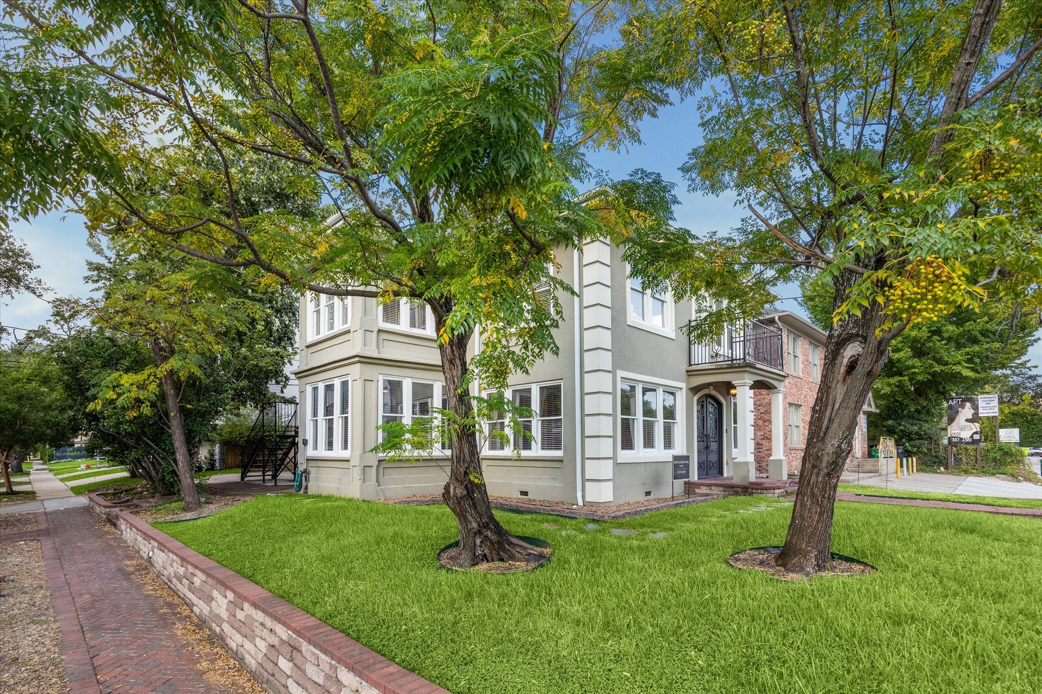 1220 West Gray Street Houston, TX 77019 - Photo 2 of 49 a house that has a tree in front of it