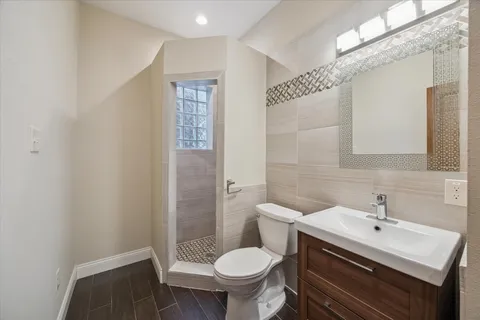 a bathroom with a sink toilet and a mirror