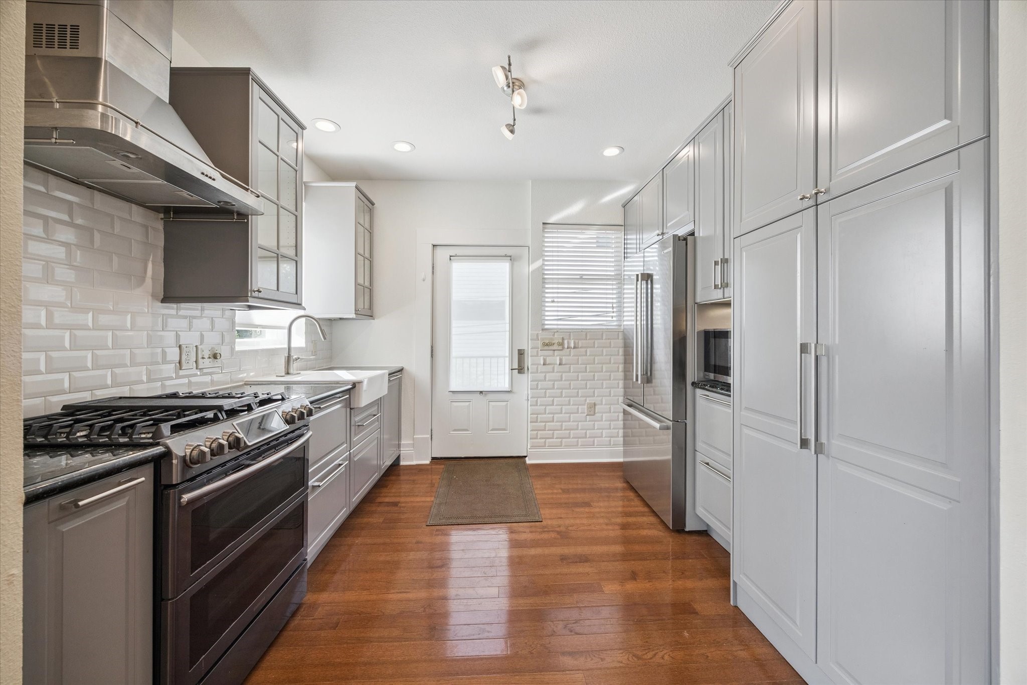 1220 West Gray Street Houston, TX 77019 - Photo 27 of 49 a kitchen with stainless steel appliances a refrigerator stove and sink