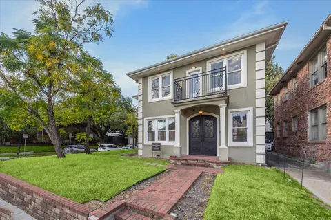 a front view of a house with a garden