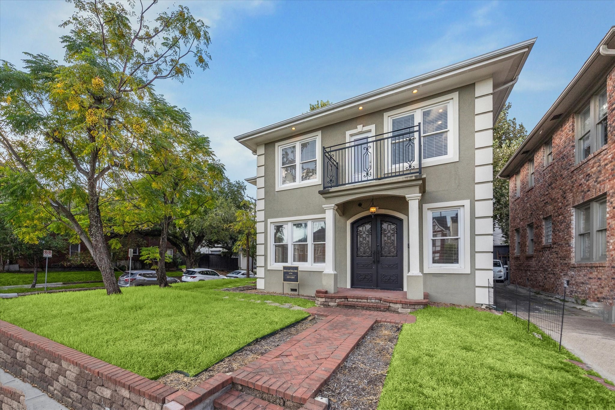 1220 West Gray Street Houston, TX 77019 - Photo 3 of 49 a front view of a house with a garden