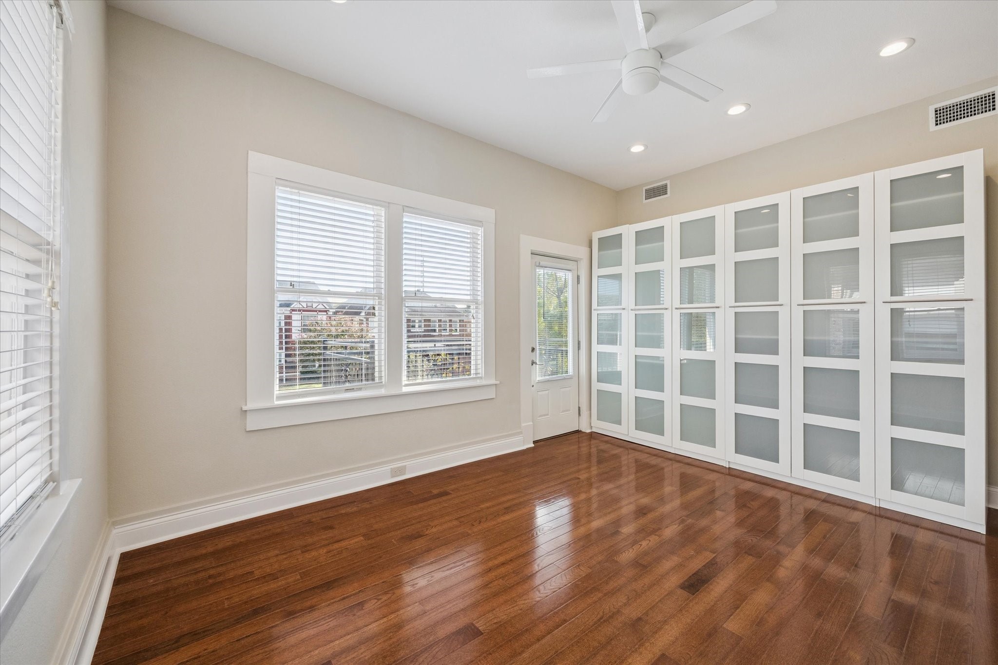 1220 West Gray Street Houston, TX 77019 - Photo 36 of 49 a view of an empty room with a window and wooden floor