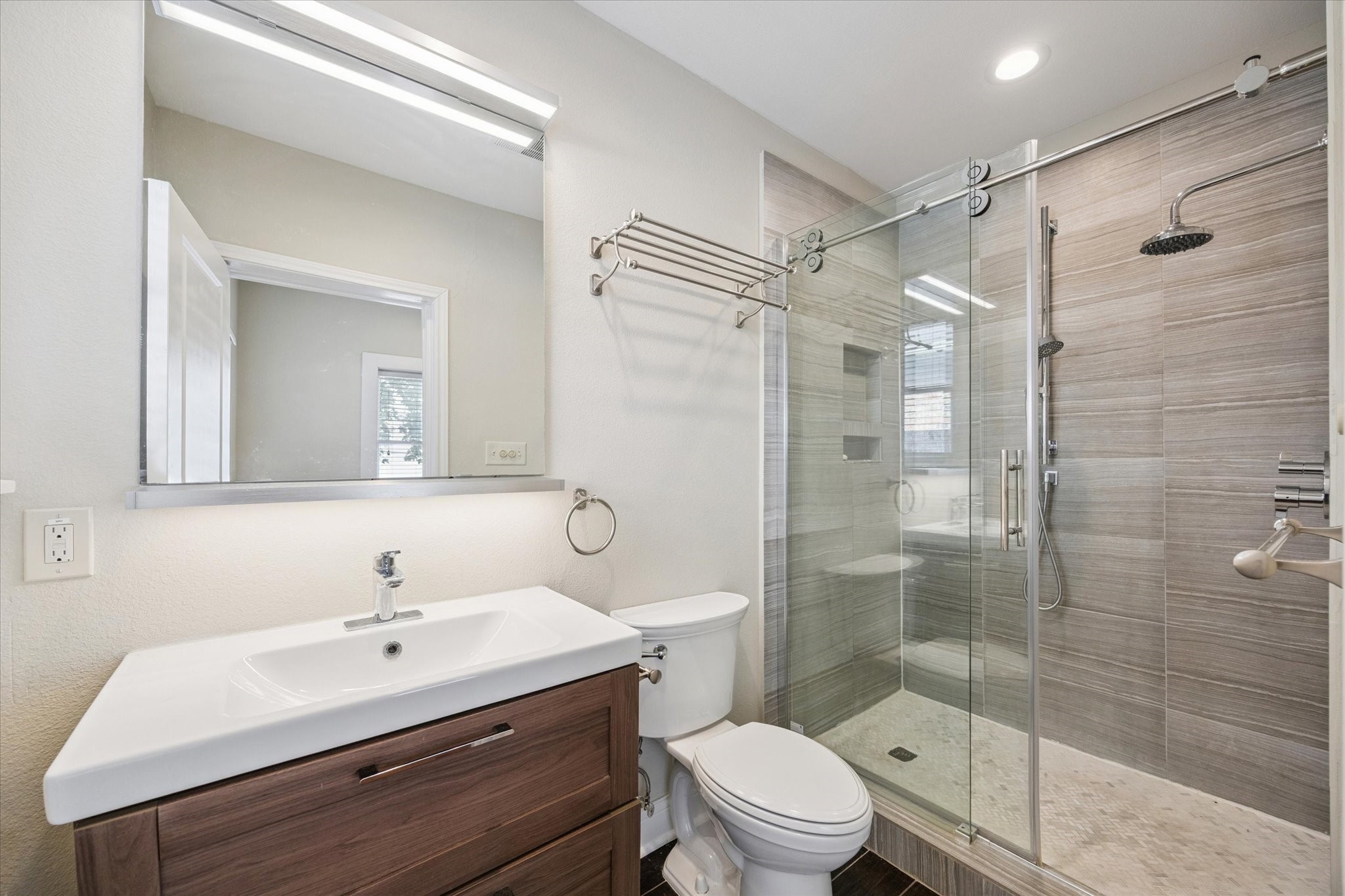 1220 West Gray Street Houston, TX 77019 - Photo 37 of 49 a bathroom with a sink toilet a mirror and shower
