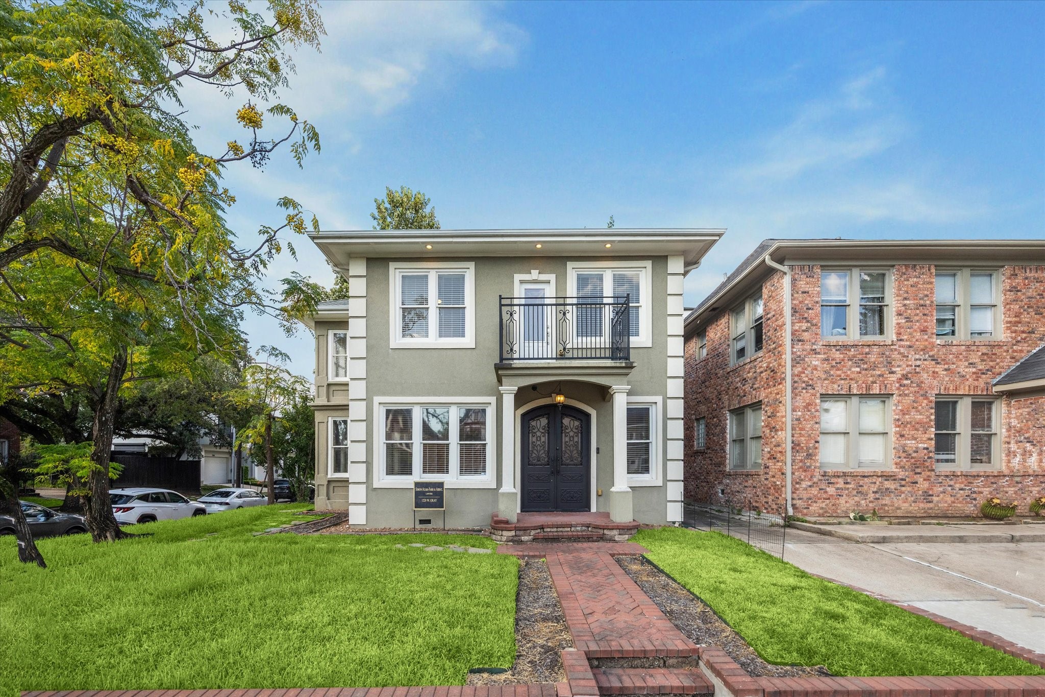 1220 West Gray Street Houston, TX 77019 - Photo 4 of 49 a front view of a house with a yard