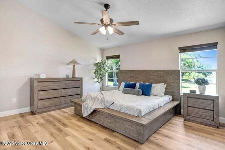 3360 Holly Springs Road Melbourne, FL 32934 - Photo 14 of 30 a bedroom with a bed and a dresser