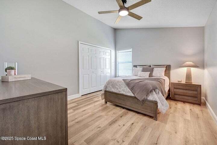 3360 Holly Springs Road Melbourne, FL 32934 - Photo 19 of 30 a bedroom with a bed and a dresser