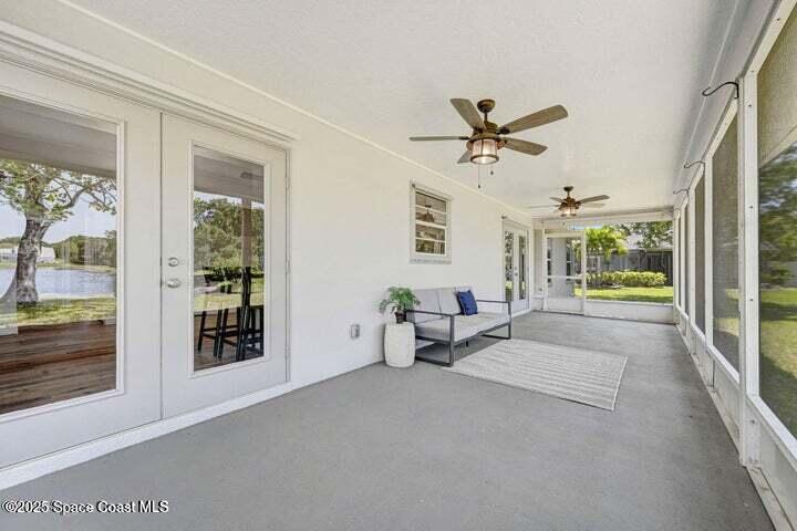3360 Holly Springs Road Melbourne, FL 32934 - Photo 23 of 30 a living room with furniture and large windows