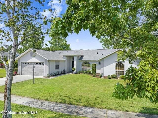 3360 Holly Springs Road Melbourne, FL 32934 - Photo 28 of 30 a front view of a house with a yard and trees