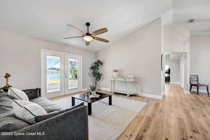 3360 Holly Springs Road Melbourne, FL 32934 - Photo 4 of 30 a living room with furniture and a large window
