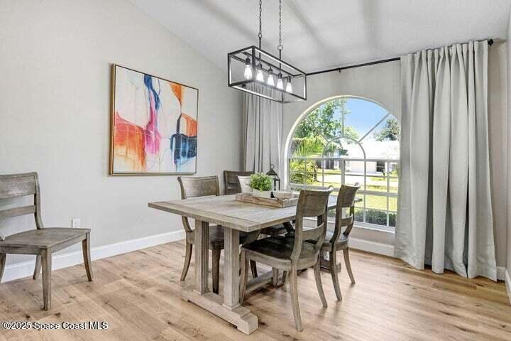 3360 Holly Springs Road Melbourne, FL 32934 - Photo 5 of 30 a view of a dining room with furniture window and wooden floor