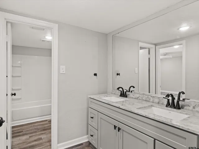 a bathroom with a sink and a mirror