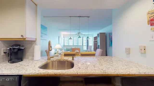 a kitchen with stainless steel appliances granite countertop a sink refrigerator and microwave