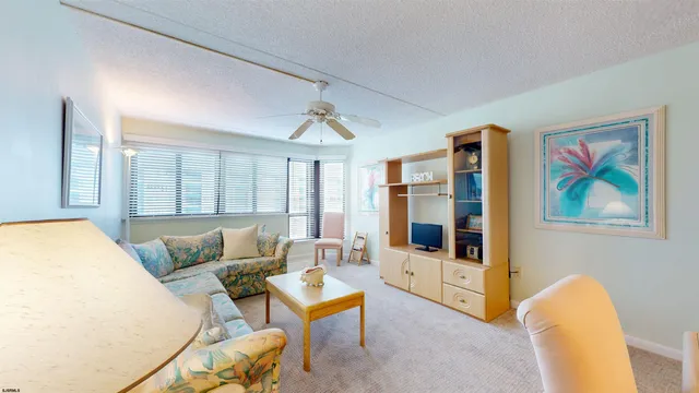 a living room with furniture and a lamp