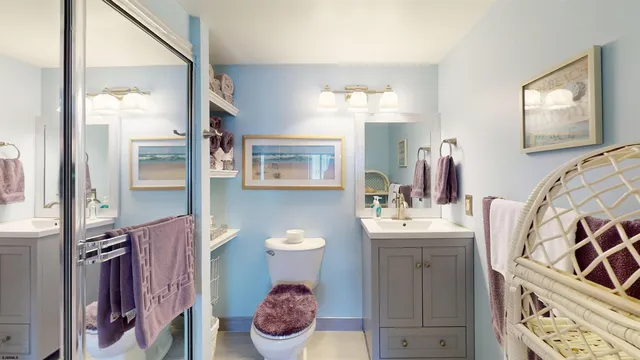 a bathroom with a toilet sink and shower curtain