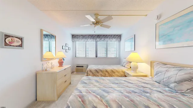 a bedroom with two beds and a window