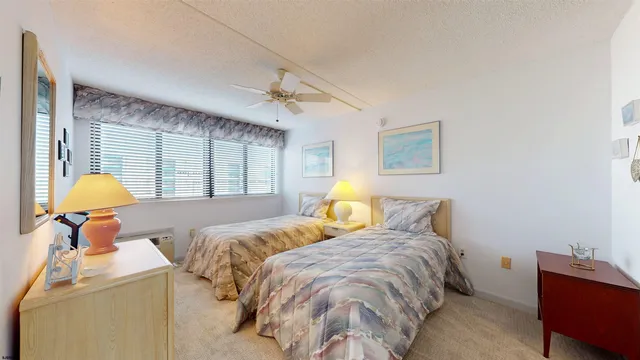 a bedroom with a bed and a lamp on table