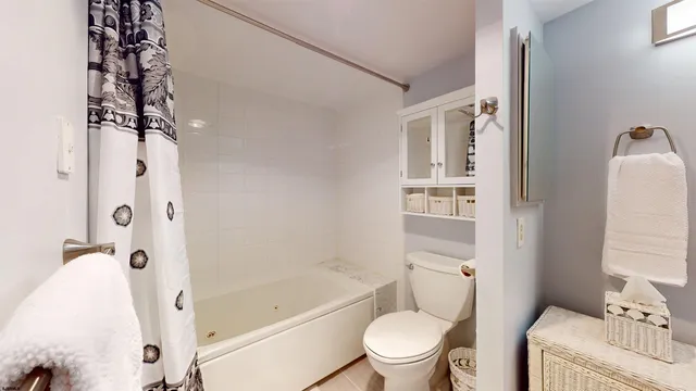 a bathroom with a double vanity sink toilet and shower