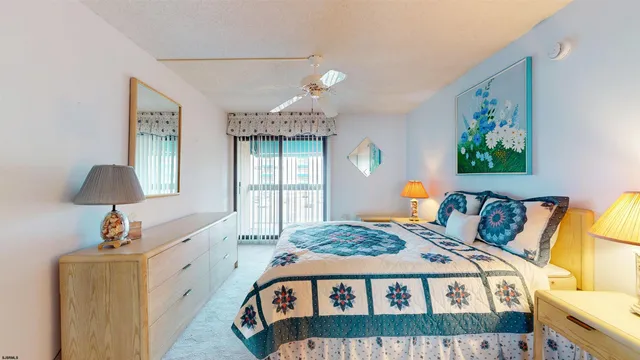 a bedroom with a bed a couch and a painting on the wall