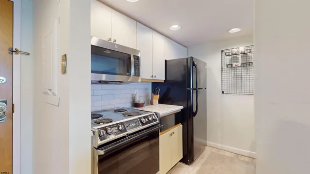 a kitchen with a sink and a wooden floor