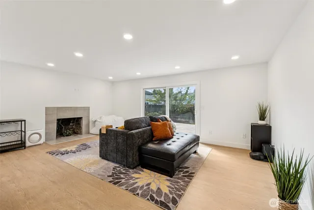 a living room with furniture a fireplace and a potted plant