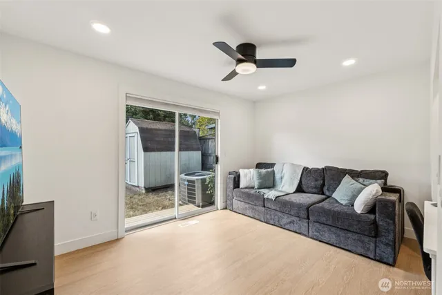 a living room with furniture and a ceiling fan
