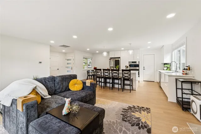 a living room with furniture and kitchen view