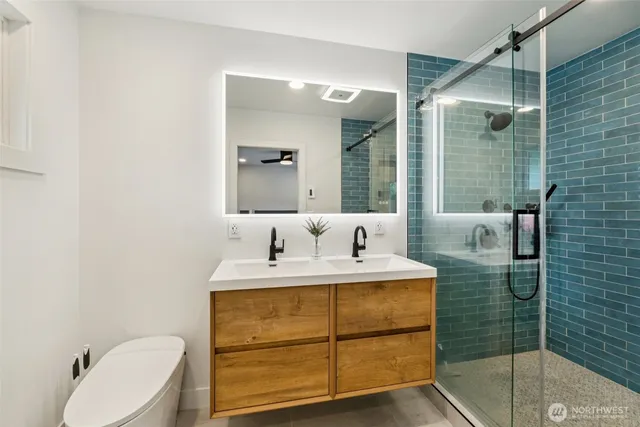 a bathroom with a sink double vanity and tub
