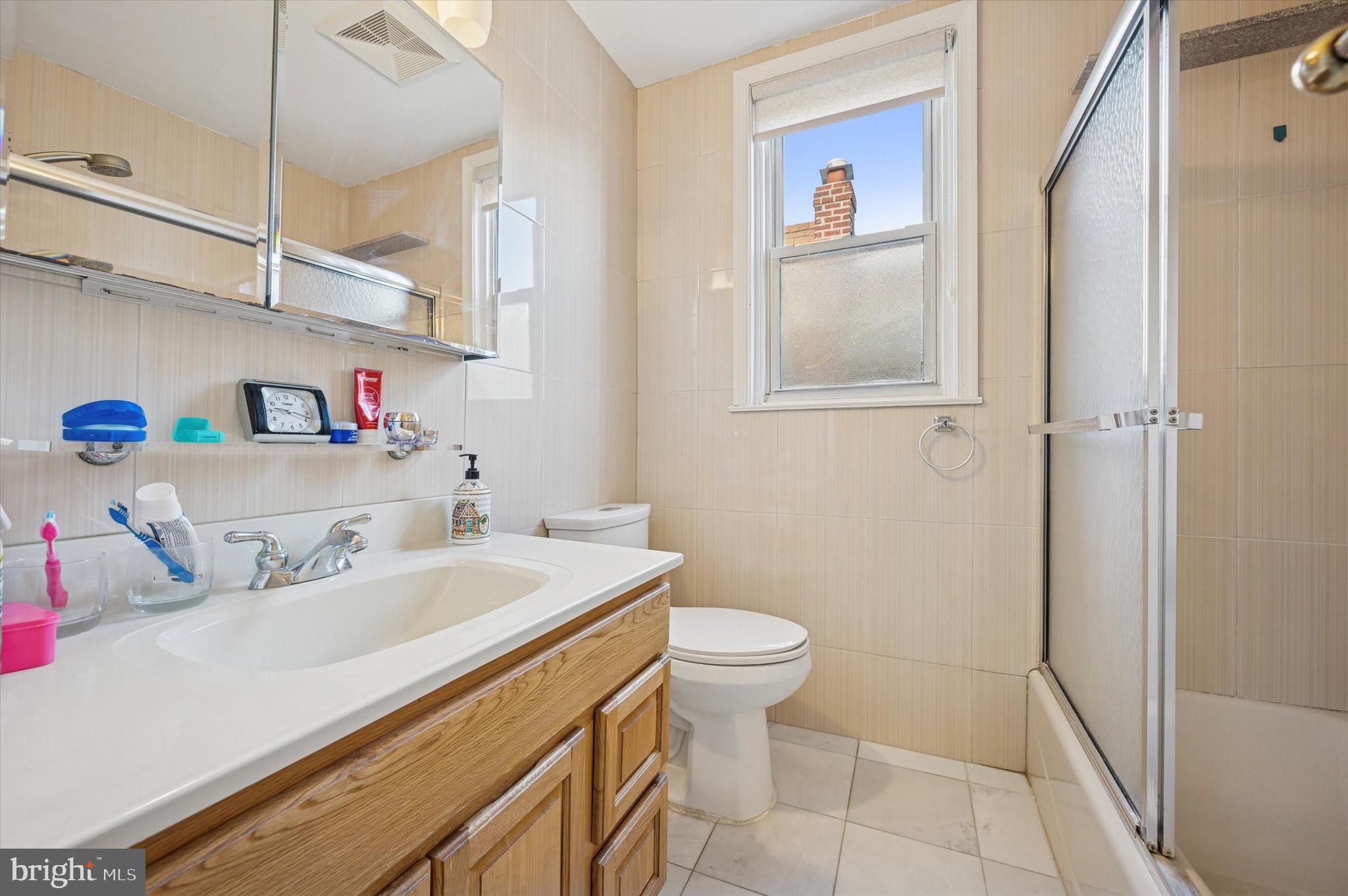 1813 Bergen Street Philadelphia, PA 19152 - Photo 12 of 15 a bathroom with a sink a toilet and a mirror