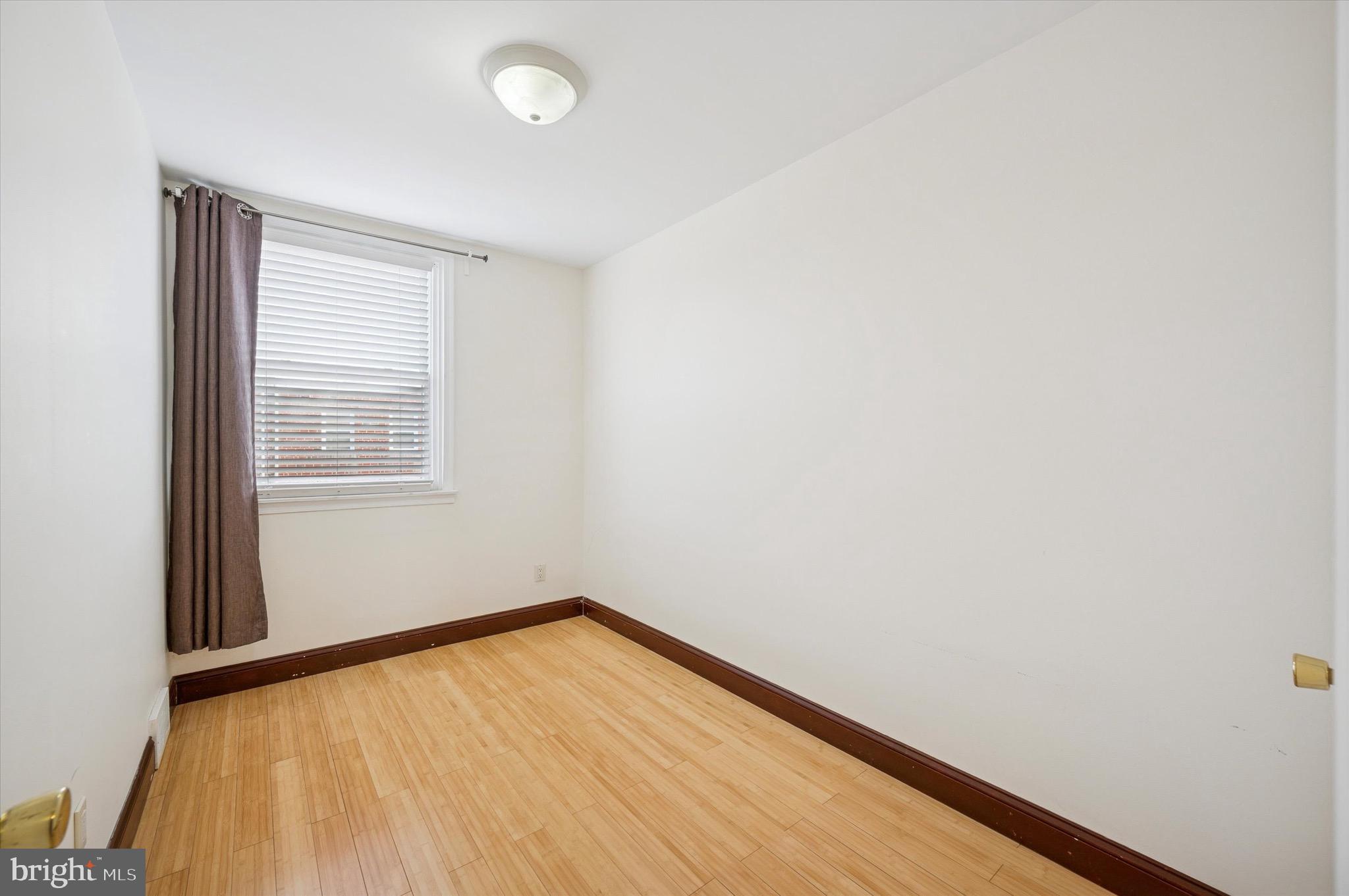 1813 Bergen Street Philadelphia, PA 19152 - Photo 8 of 15 a view of an empty room with wooden floor and a window