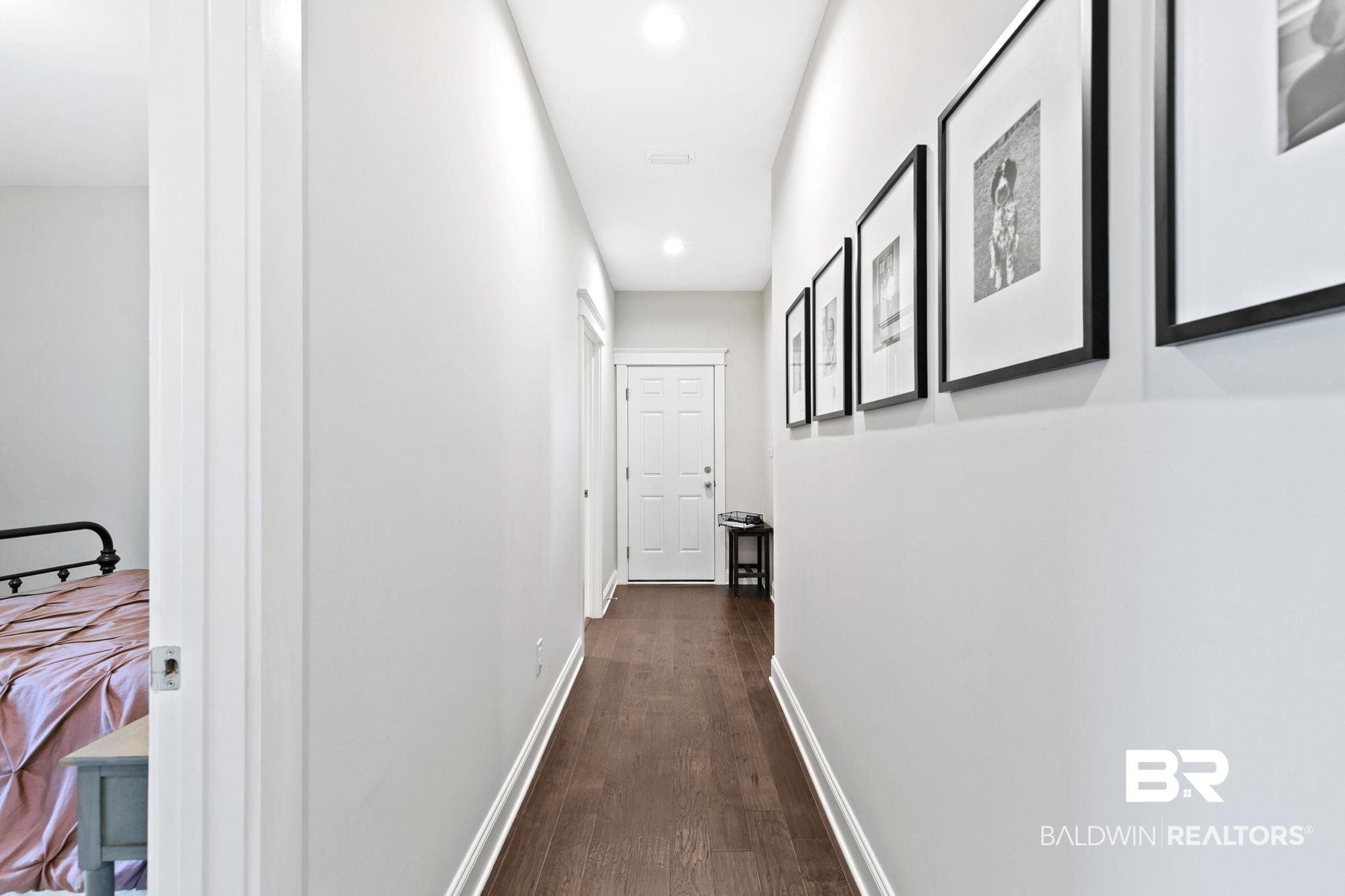 13233 Ibis Boulevard Daphne, AL 36527 - Photo 50 of 100 Hallway featuring wood-finish flooring, white baseboards, recessed lighting, and a white paneled door